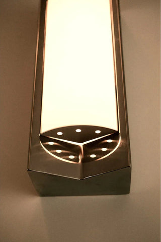 Close-up of the arrow wall light with diffuser in stainless stell from Violaine D'harcourt